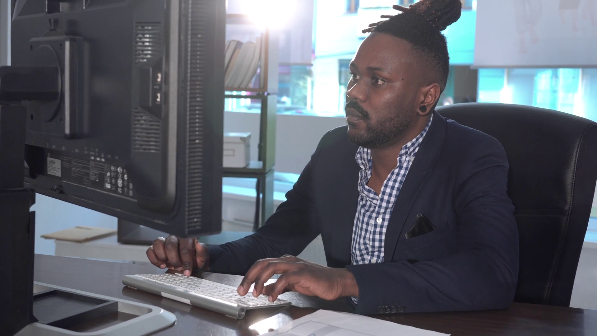 African American Office Worker At His Desk Working At Computer 